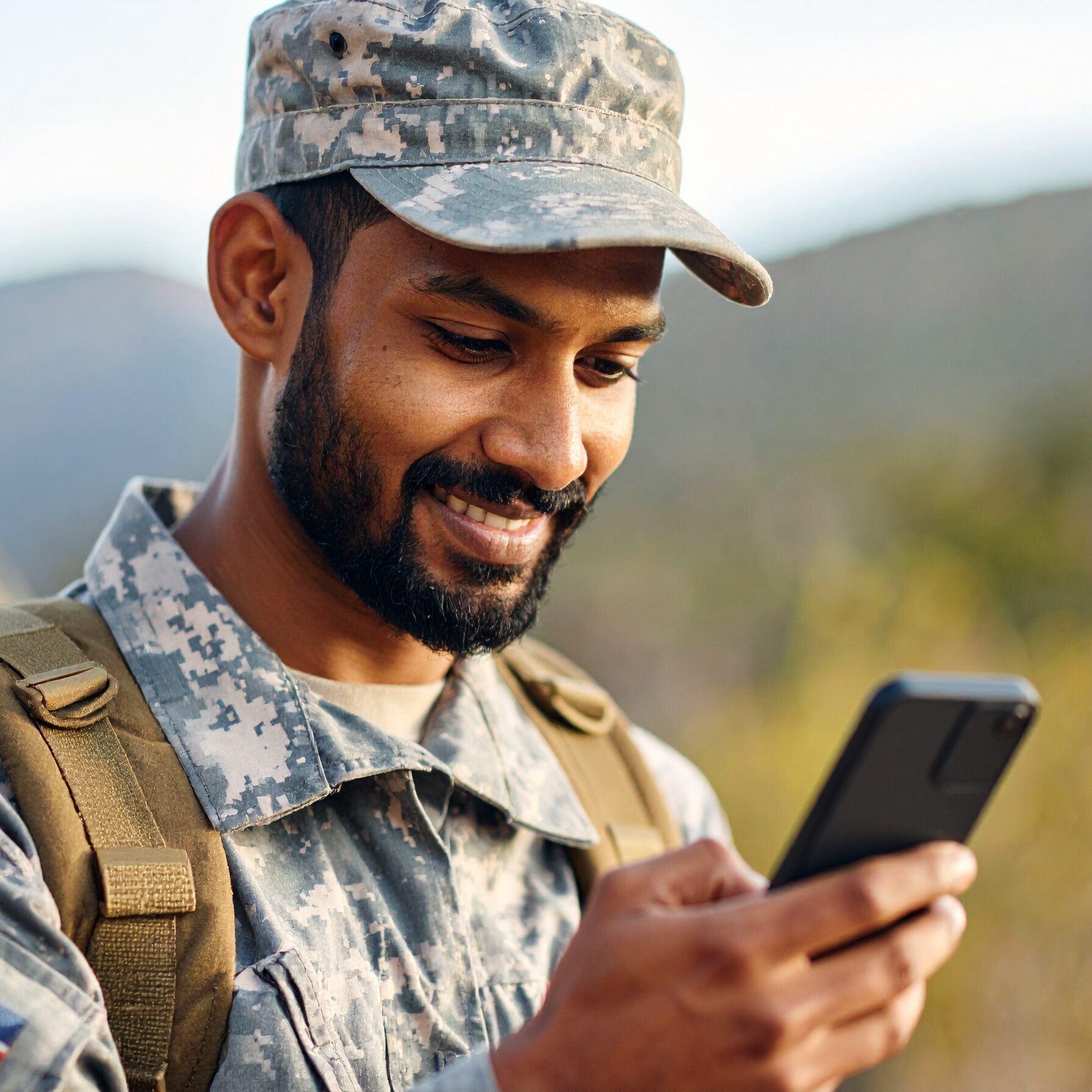 military reading an email on his phone